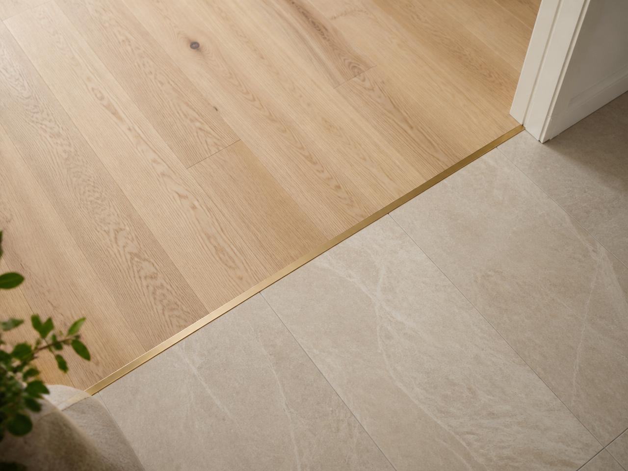 Wood-to-tile with flush brass T-molding